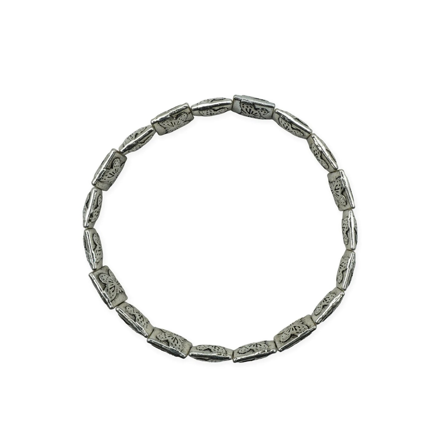 Scale view of botanical silver-plated bracelet showing engraved floral bead details.