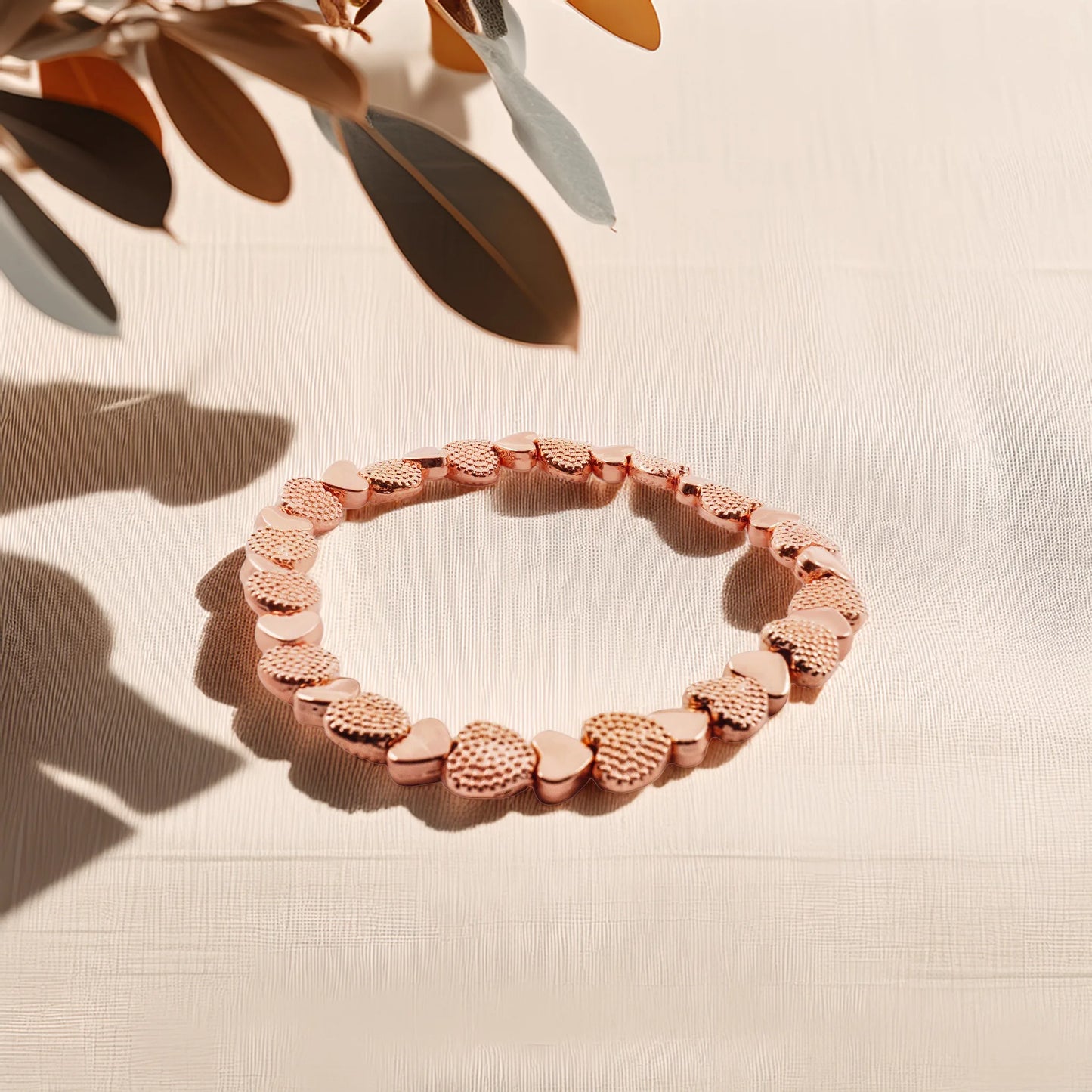 Model wearing the rose gold heart stretch bracelet by Camins Fashion, styled in natural light with warm tones, showcasing its romantic, minimalist charm and everyday elegance.