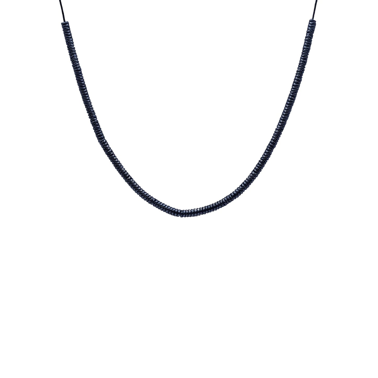 Close-up of Midnight Hematite Sliding Knot Necklace by Camins, featuring dark hematite beads on a black silk cord—handmade in Bali with minimalist, boho-chic elegance.