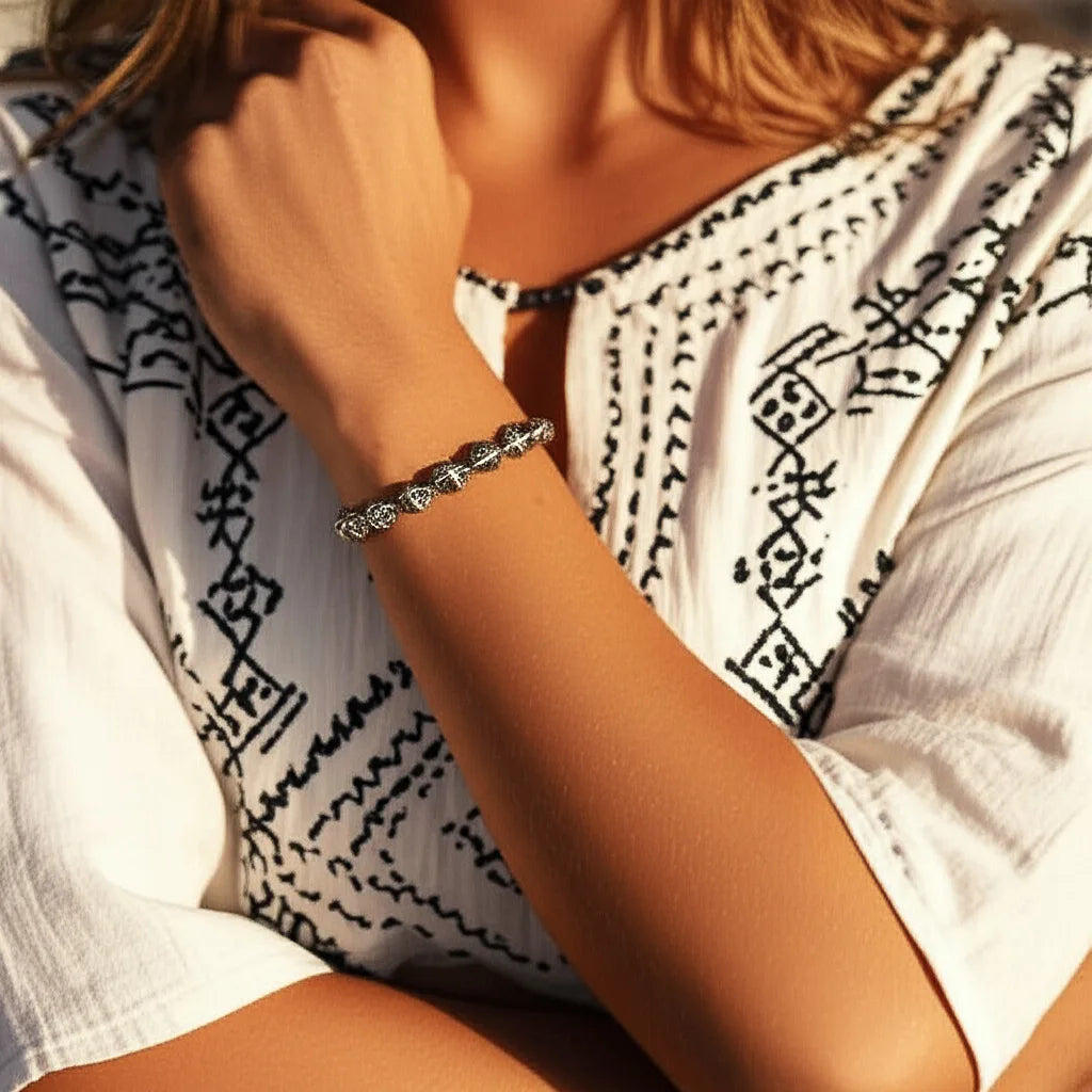 Lifestyle view of the Enchanted Hearts Bracelet, featuring silver heart charms in a romantic boho style, worn gracefully and handmade in Bali.