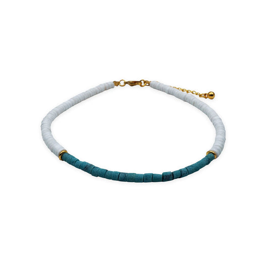 Front view of the Coastal Harmony Anklet handmade with natural white puka shell beads, accented with turquoise tones. The design highlights a simple yet coastal-inspired aesthetic, reflecting Bali’s artisanal craftsmanship