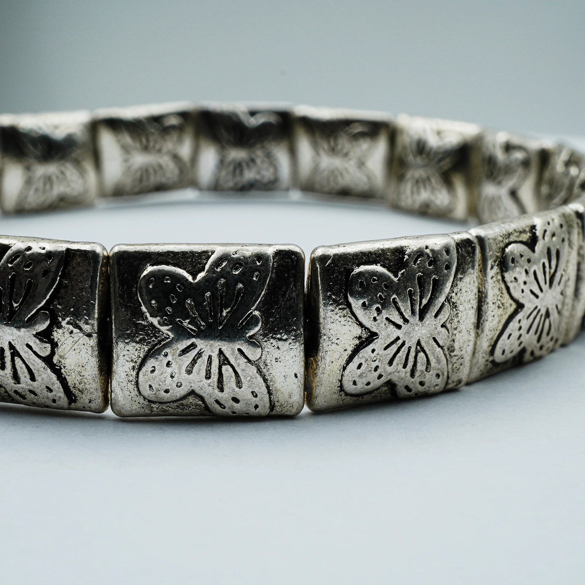 Close-up of handmade silver-plated bracelet with engraved botanical beads from the Silver Soul Collection.