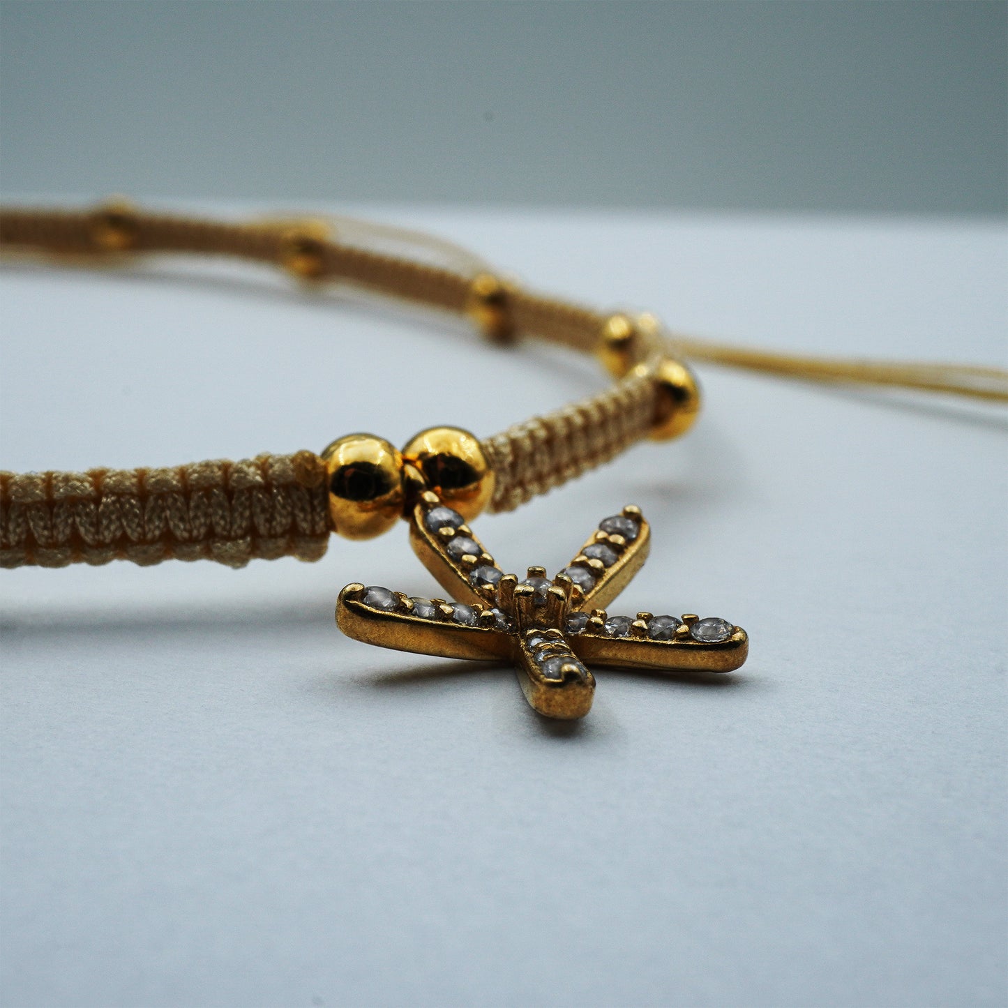 Close-up of the Golden Starfish Anklet handmade in Bali. Detailed view of golden starfish charm and sparkling beads, crafted with bohemian coastal artistry.