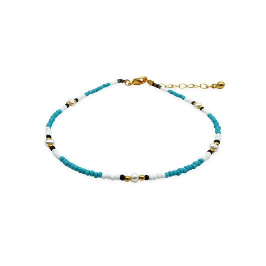 Front view of handmade anklet with pearls, glass beads, and gold details from Bali.