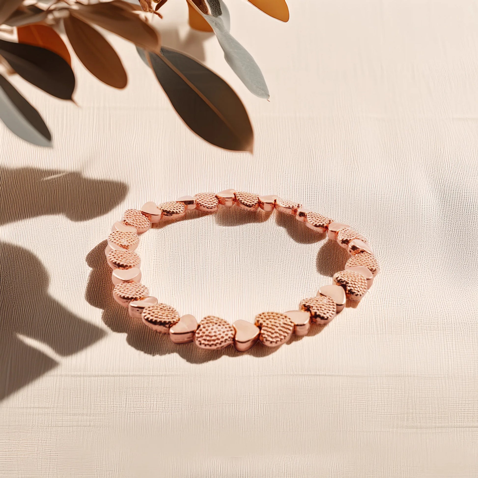Model wearing the rose gold heart stretch bracelet by Camins Fashion, styled in natural light with warm tones, showcasing its romantic, minimalist charm and everyday elegance.