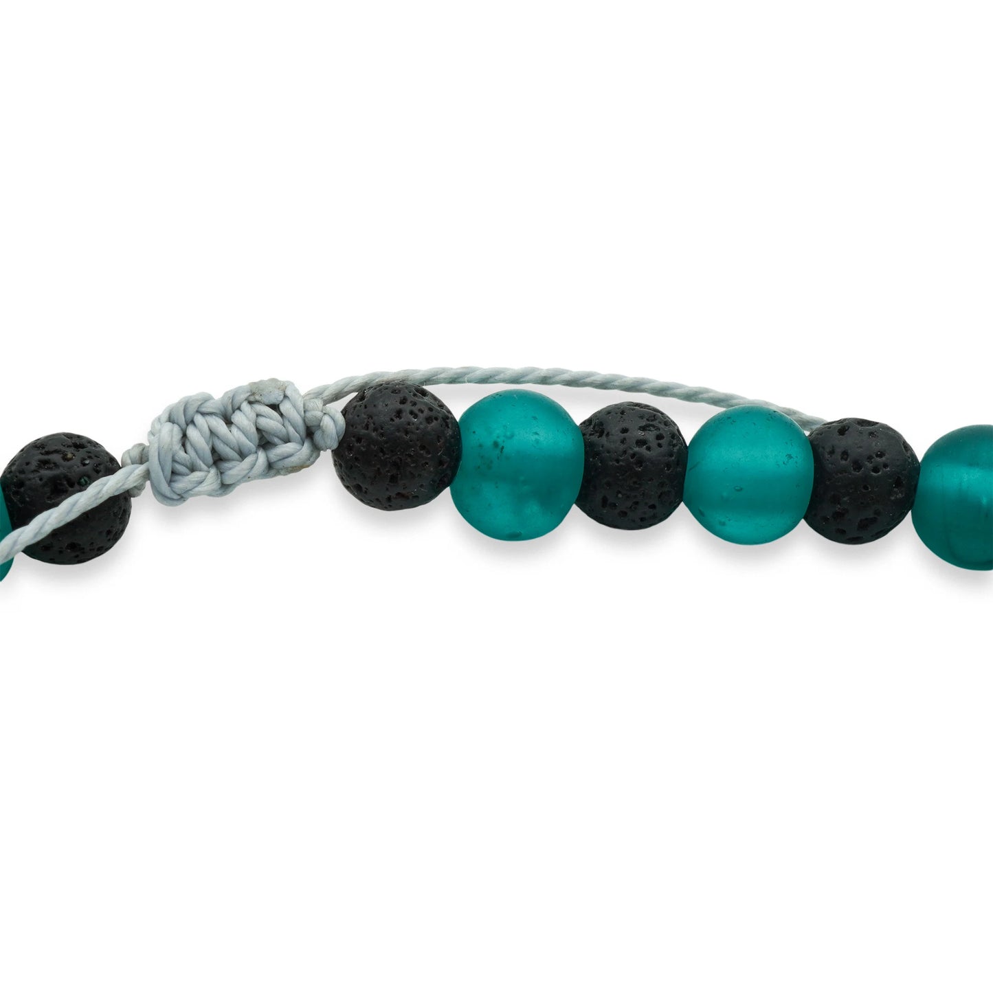 Close-up of the Verdant Tide Sliding Bead Necklace featuring smooth green seaglass and porous black lava beads on a dark waxed cord — highlighting the natural textures and handcrafted coastal elegance of Camins Fashion.