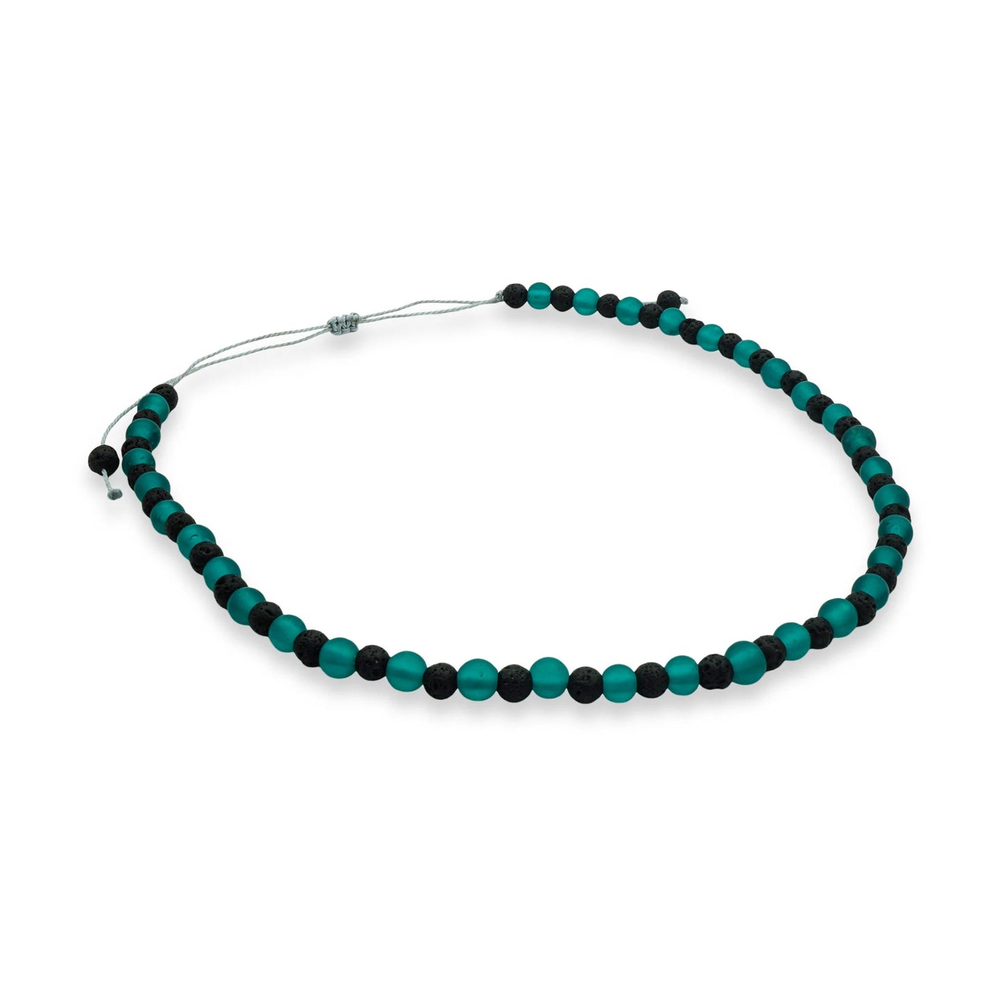 Top view of the Verdant Tide Sliding Bead Necklace featuring matte green seaglass and black lava beads strung on a waxed cord — a handcrafted coastal-inspired design from Camins Fashion.