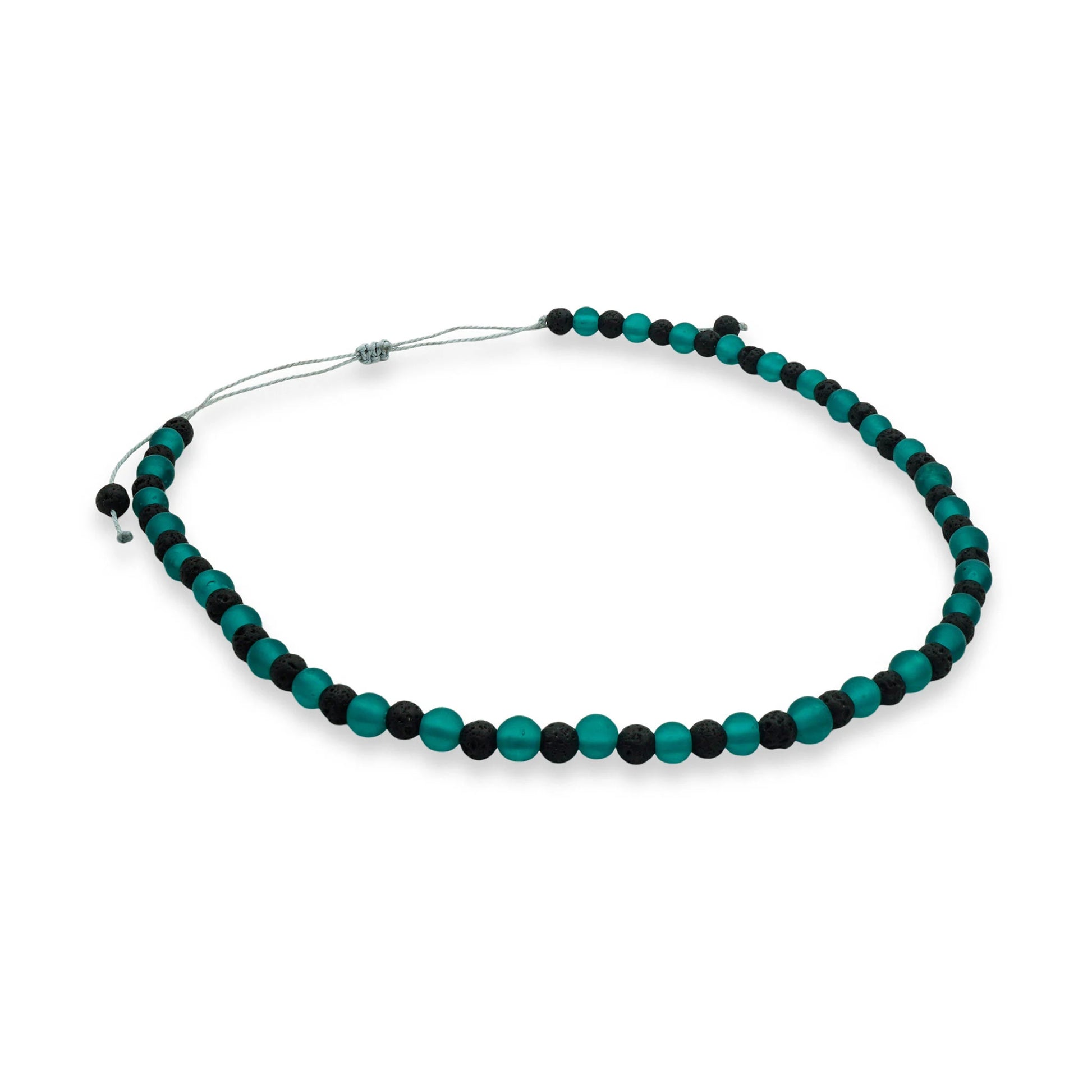 Top view of the Verdant Tide Sliding Bead Necklace featuring matte green seaglass and black lava beads strung on a waxed cord — a handcrafted coastal-inspired design from Camins Fashion.