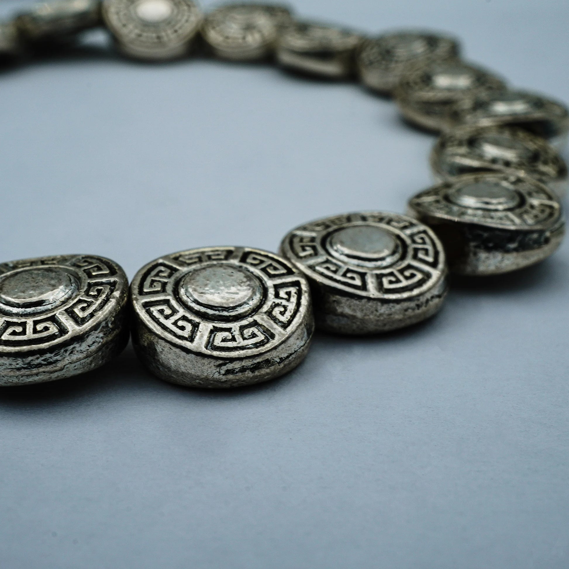 Close-up of the Ancient Coin Bracelet showcasing detailed vintage silver coin charms and boho elegance, handcrafted in Bali with artisanal precision.