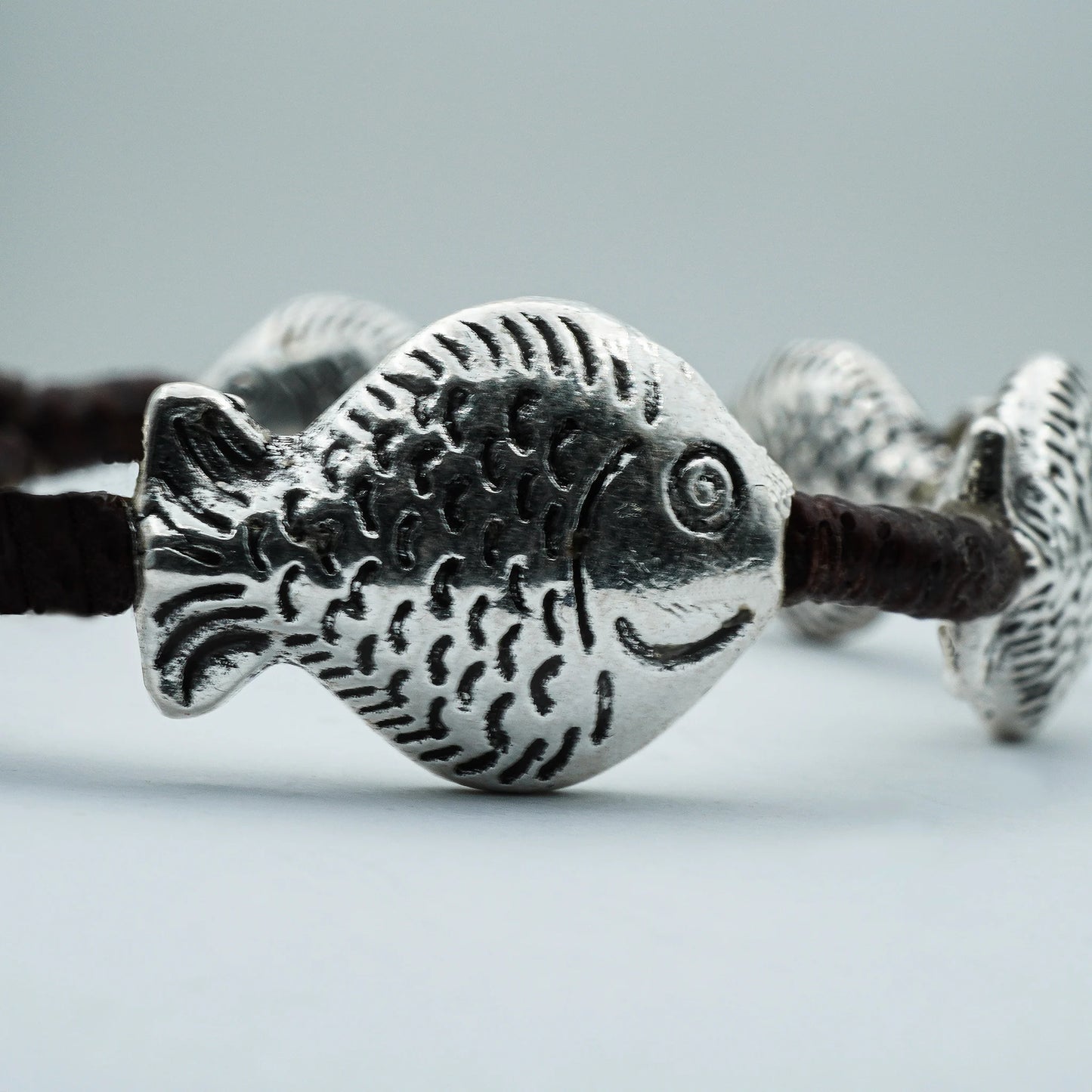 Close-up of the Boho Spirit Beaded Bracelet showcasing ocean-inspired beads and a detailed tribal fish charm, handmade with coastal boho elegance.