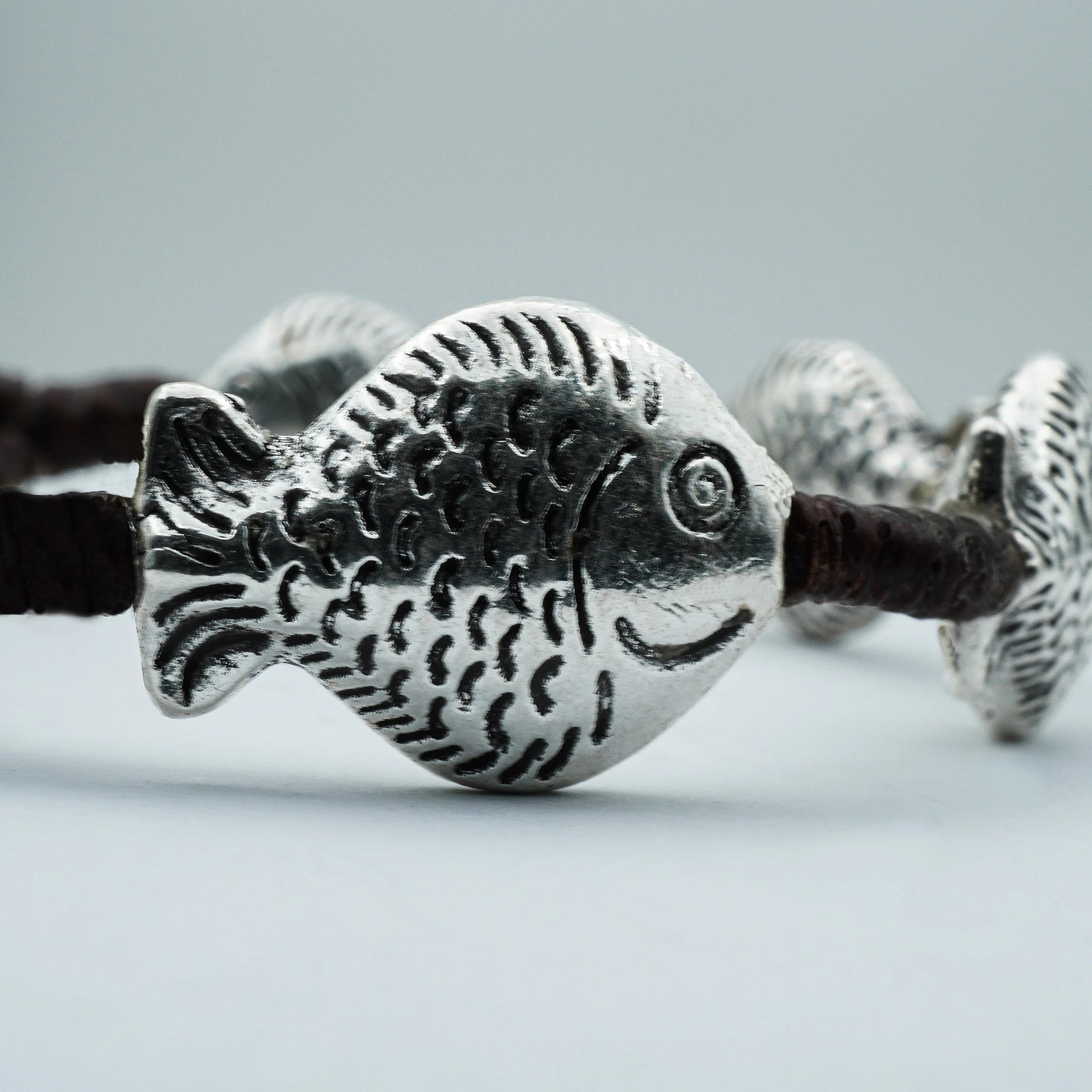 Close-up of the Boho Spirit Beaded Bracelet showcasing ocean-inspired beads and a detailed tribal fish charm, handmade with coastal boho elegance.