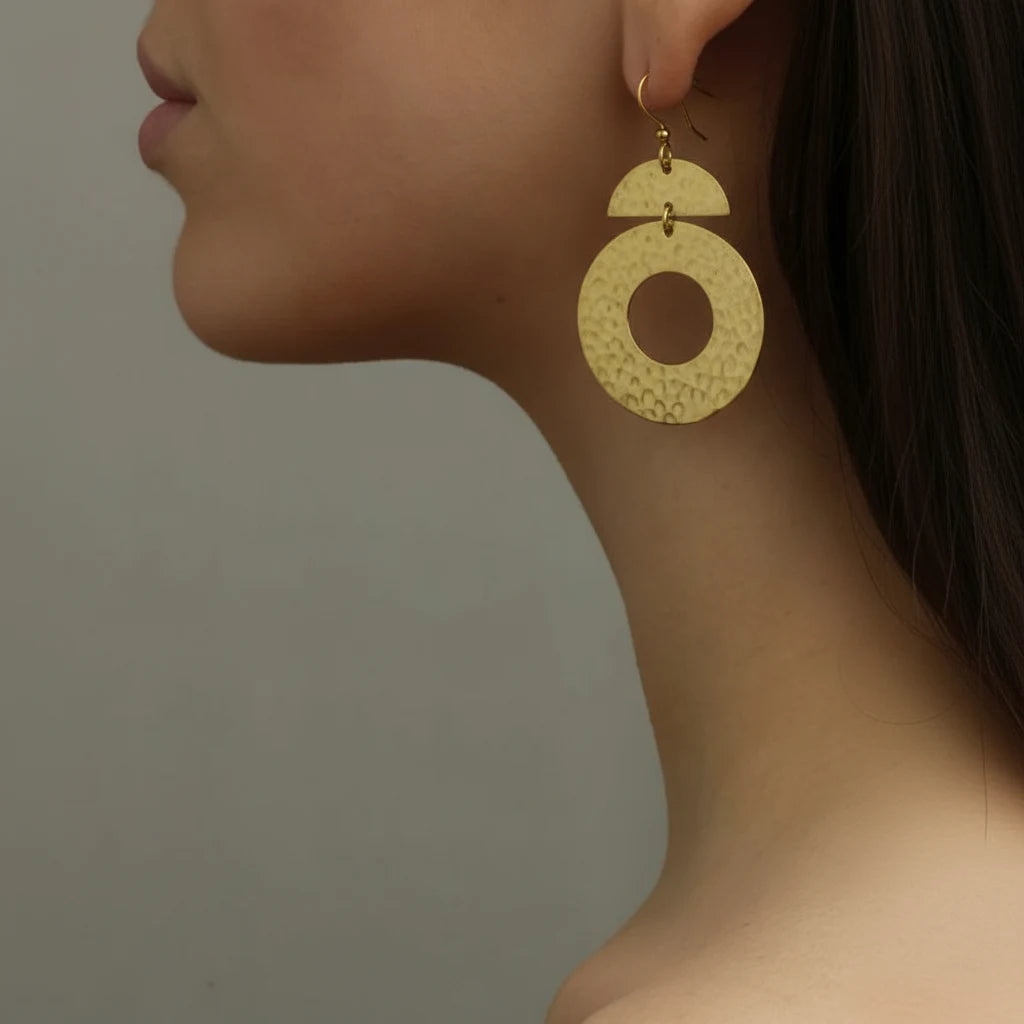 Lifestyle close-up of handmade Geo Sunburst brass earrings, bold hammered design, artisanal jewelry from Bali by Camins
