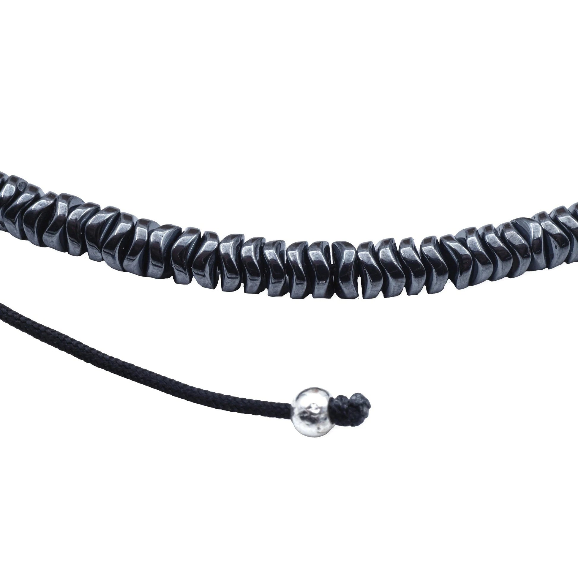 Close-up of Camins Midnight Hematite Necklace with dark reflective beads and adjustable sliding knot, handmade in Bali with minimalist boho elegance.