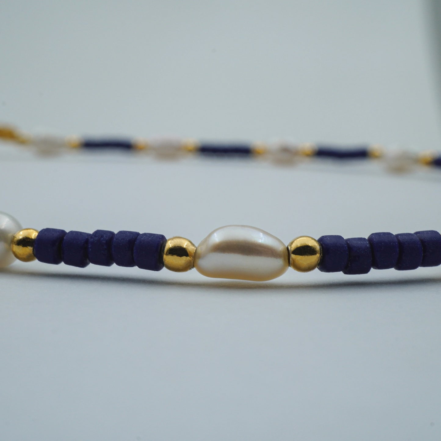 Close-up of the Celestial Pearl & Bead Anklet, highlighting lustrous freshwater pearls and shimmering glass bead details, showcasing fine Balinese craftsmanship.