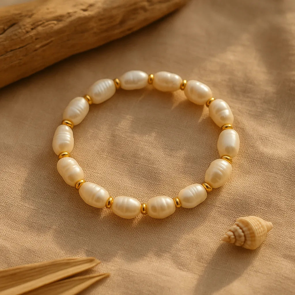 A stretch bracelet made of irregular white freshwater pearls accented with small gold beads, arranged in a circle on a white background — minimalist boho jewelry with Mediterranean-inspired elegance