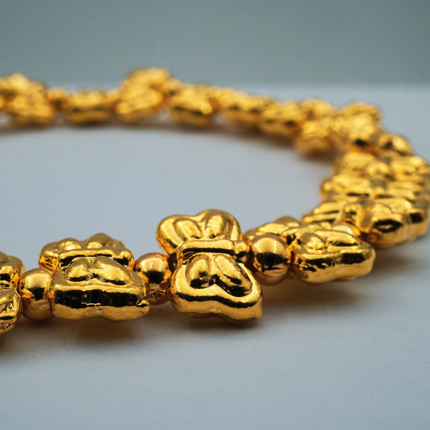 Close-up of the Golden Butterfly Stretch Bracelet by Camins Fashion, featuring radiant gold-toned butterfly beads handcrafted in Bali for an artisanal, elegant finish.