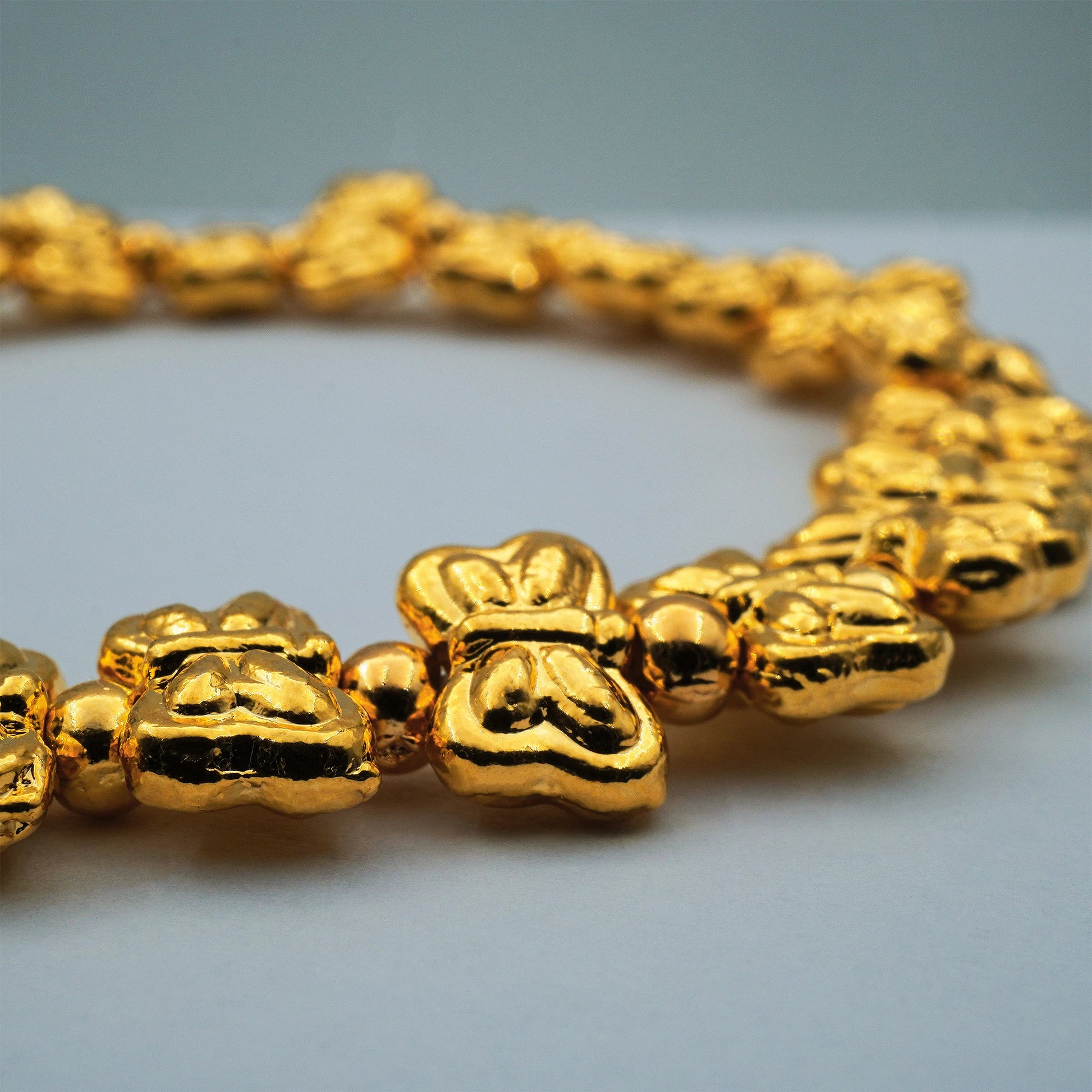 Close-up of the Golden Butterfly Stretch Bracelet by Camins Fashion, featuring radiant gold-toned butterfly beads handcrafted in Bali for an artisanal, elegant finish.