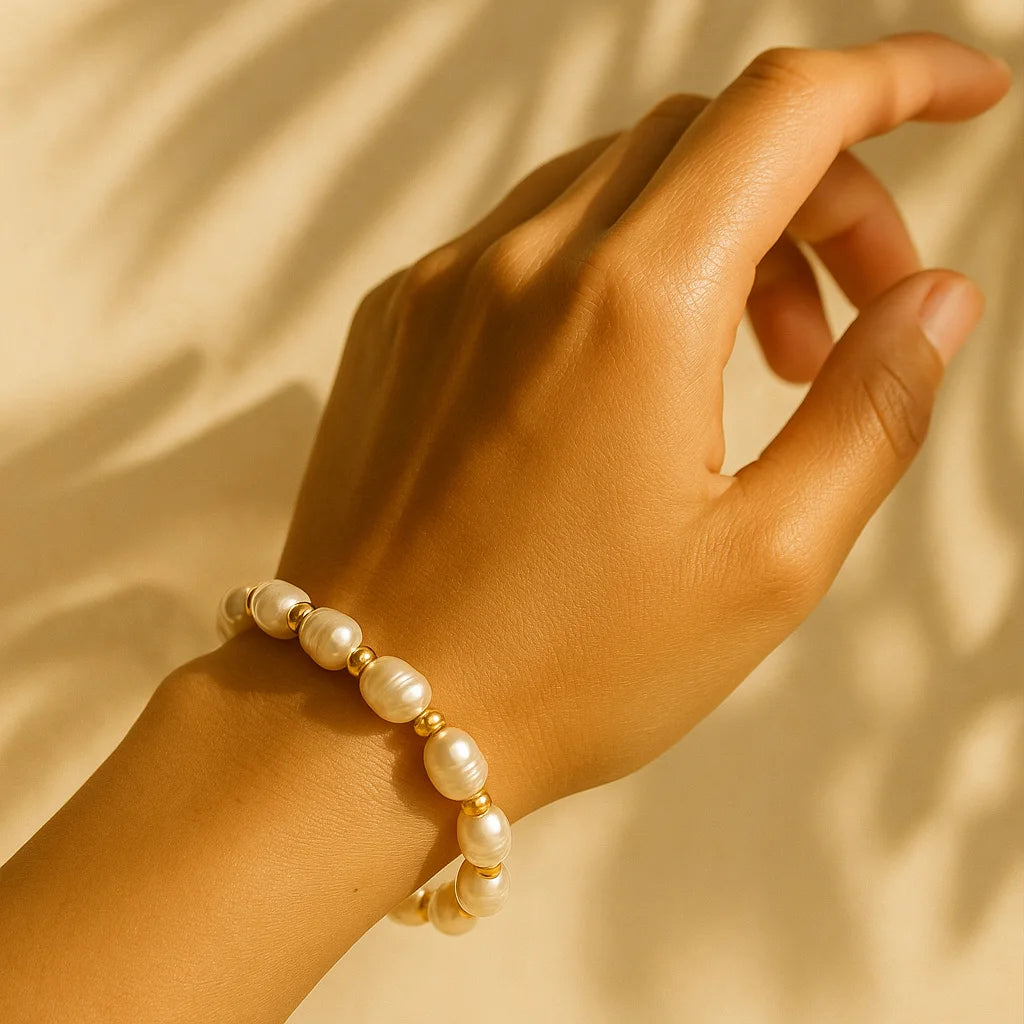 Golden Glow Freshwater Pearl Bracelet worn by a woman in natural light, highlighting the lustrous pearls and golden accents — blending modern charm with Mediterranean-inspired elegance