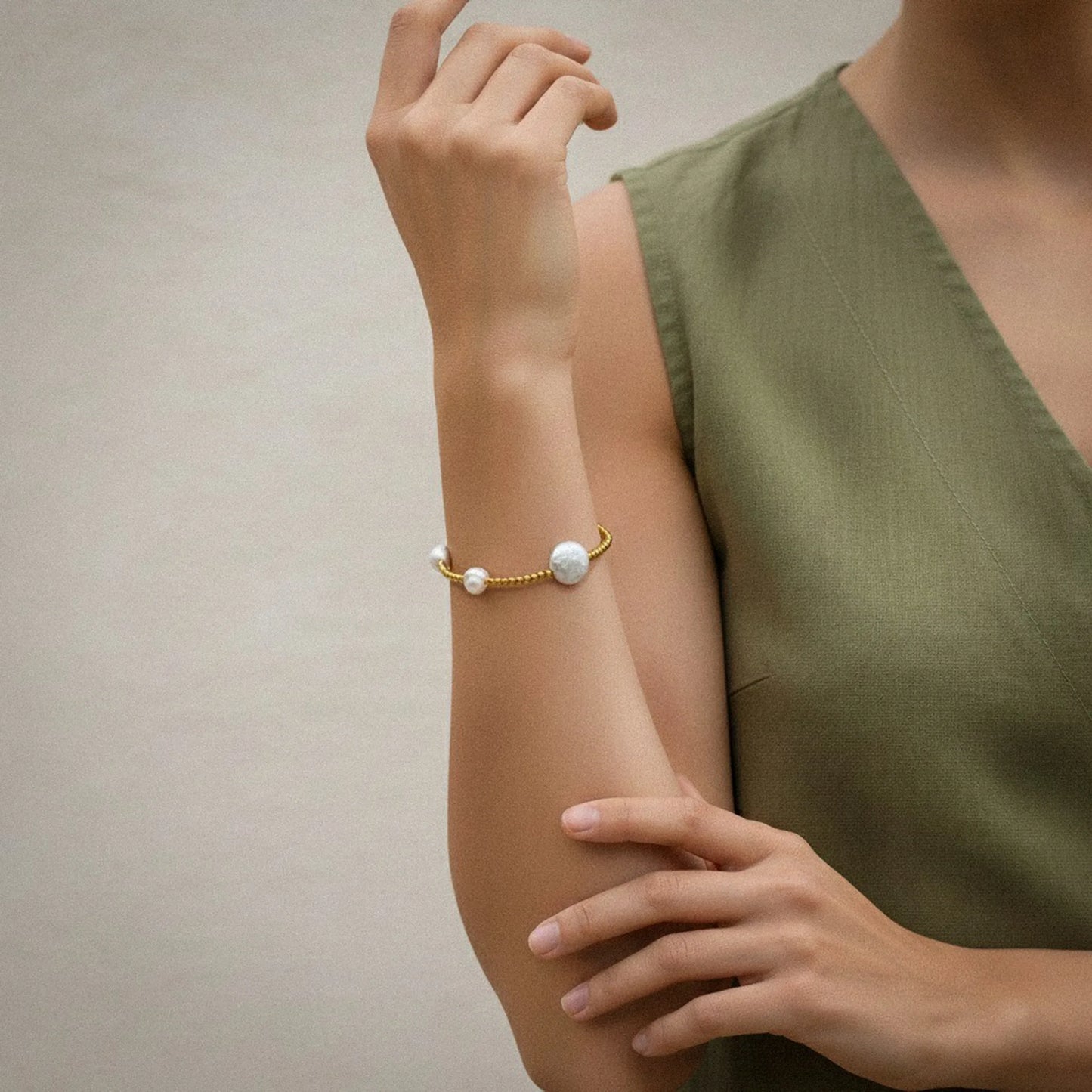 Lifestyle shot of the Golden Radiance Pearl Bracelet worn on the wrist, featuring luminous pearls paired with golden bead accents. Handmade in Bali, styled in natural light for a refined boho-chic look