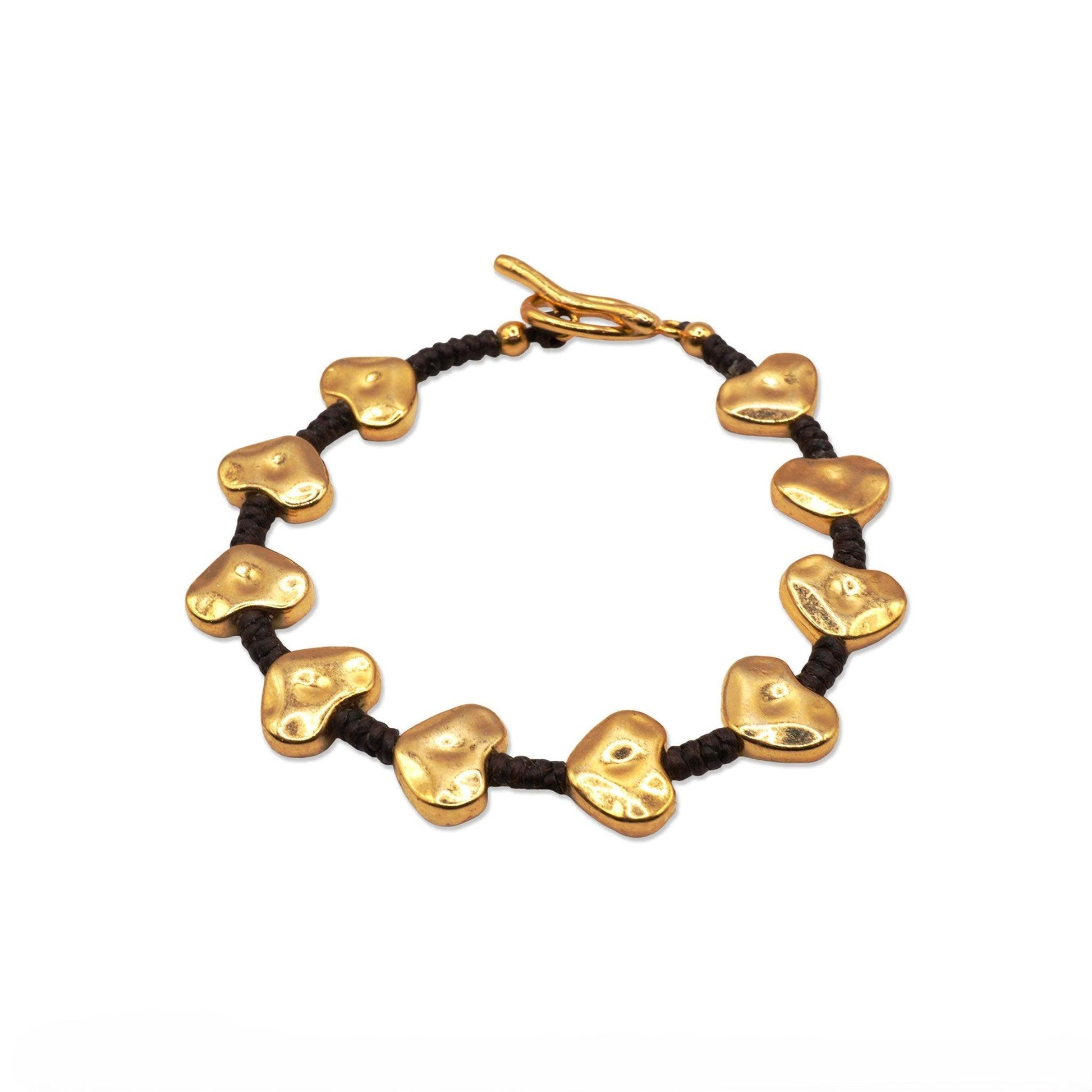 Top view of Heart Bead Glow Bracelet arranged in a circle, showcasing its symmetrical heart charms and dark cord—Camins Fashion’s blend of simplicity and warmth.
