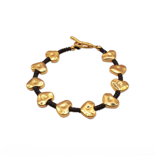 Top view of Heart Bead Glow Bracelet arranged in a circle, showcasing its symmetrical heart charms and dark cord—Camins Fashion’s blend of simplicity and warmth.