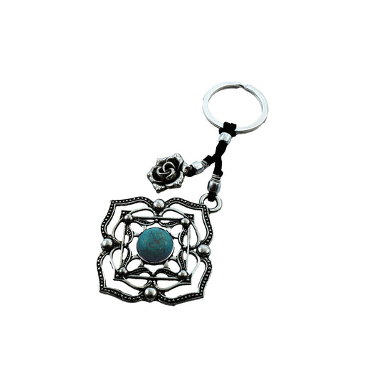 Top view of Boho Bloom Keychain showcasing its handmade flower-inspired form with a central stone detail and antique silver-plated finish, reflecting a vintage and boho-chic aesthetic.

