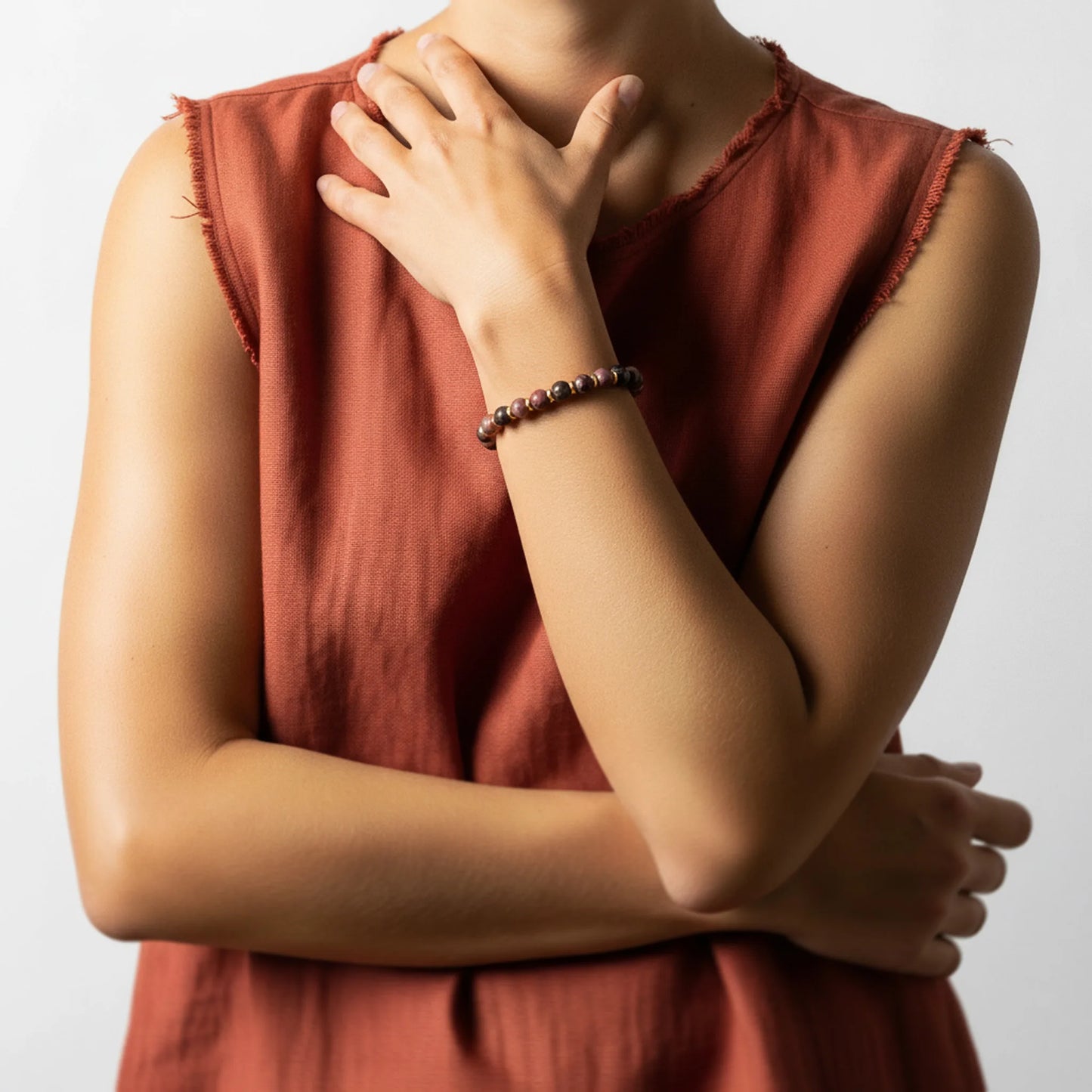 Woman wearing the Rhodonite Harmony Bracelet, showing natural pink gemstone tones and artisanal Balinese craftsmanship