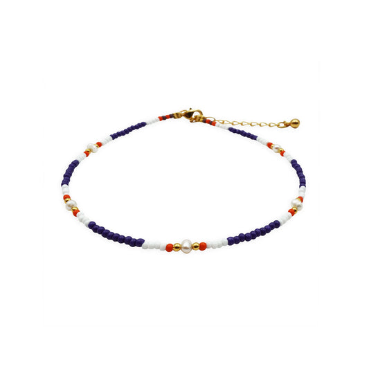 Front view of the Seaside Harmony Beaded Anklet handmade in Bali, featuring natural shell and glass beads in soft coastal tones, designed with a boho-chic Mediterranean charm.