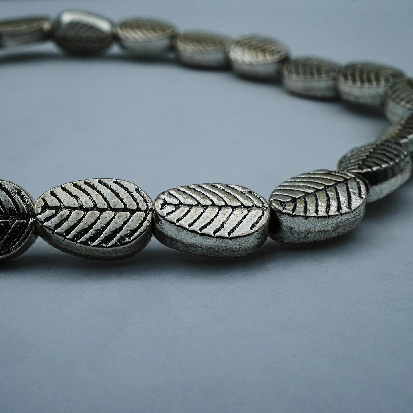 Close-up of the Serene Leaf Bracelet, highlighting the fine silver leaf patterns and detailed Balinese craftsmanship.