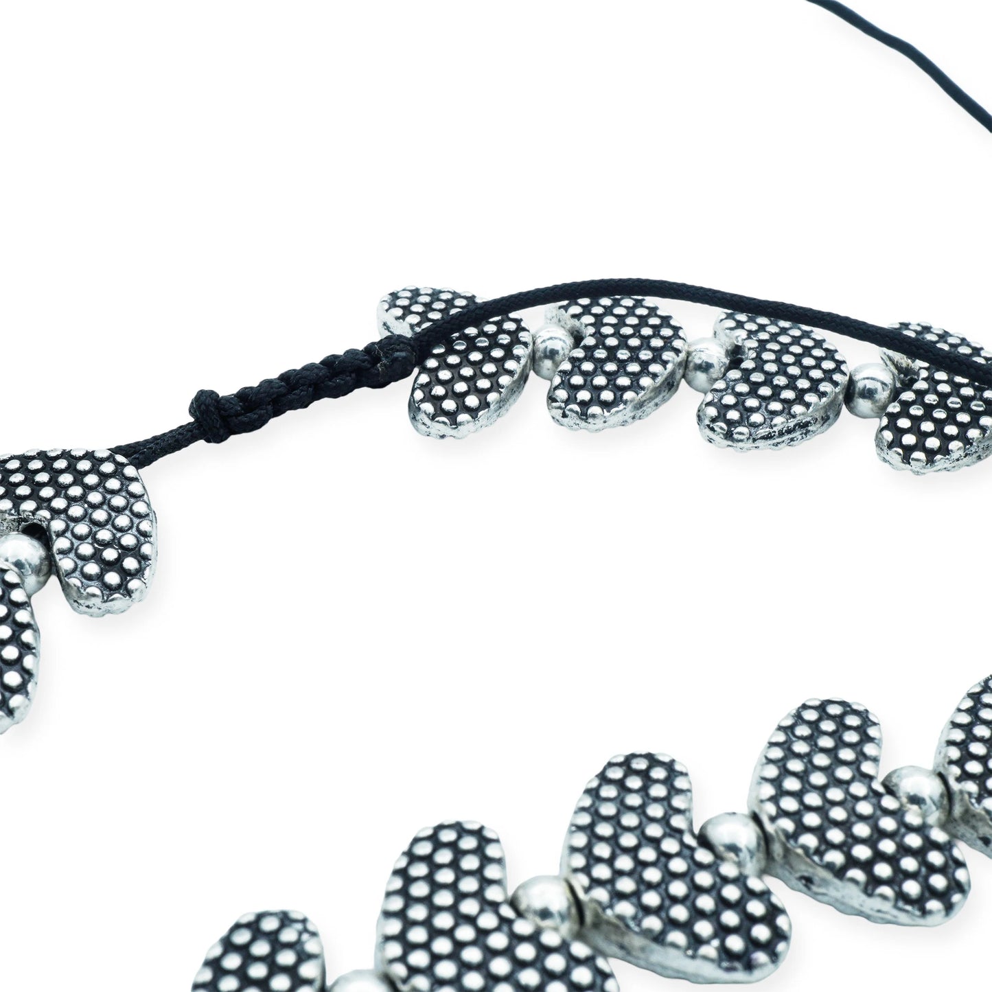 Close-up of the Silver Heartbeat Sliding Necklace showing the textured silver-plated heart beads and black silk sliding knot cord, handcrafted in Bali.
